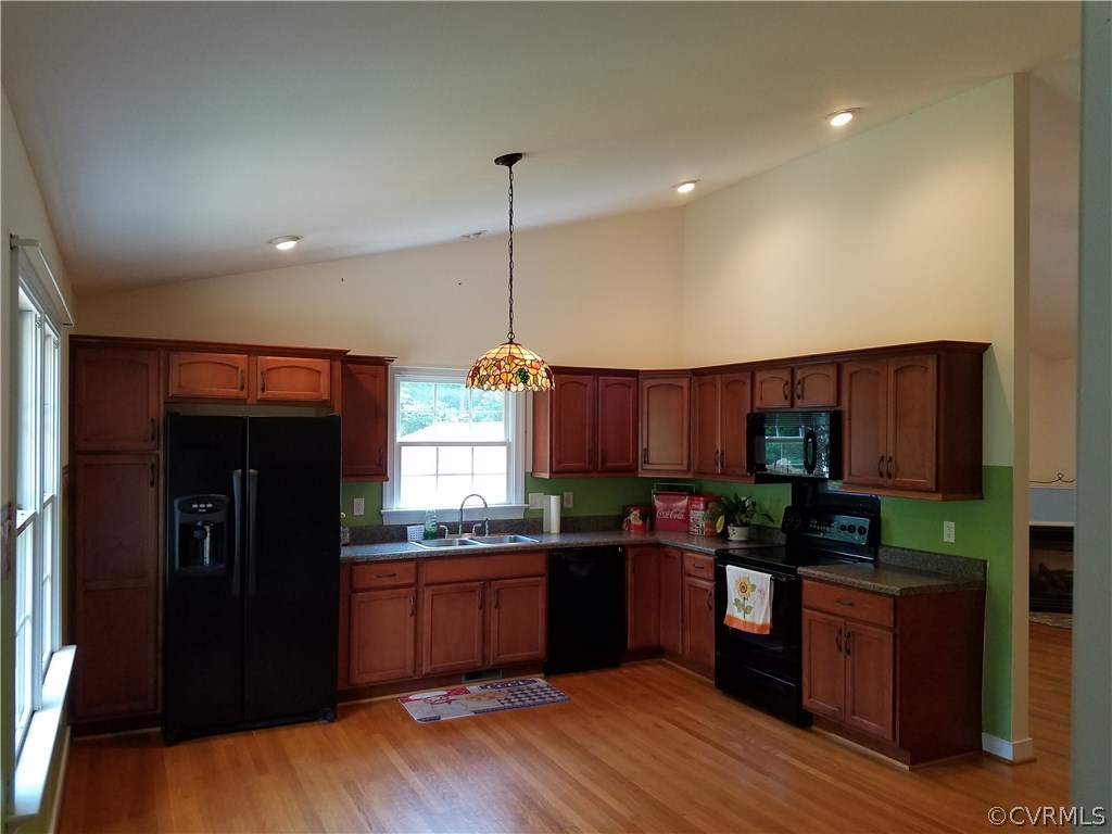 2238 Wickham Road Bumpass, VA 23024 - Photo 4 of 15 a kitchen with granite countertop stainless steel appliances and wooden cabinets