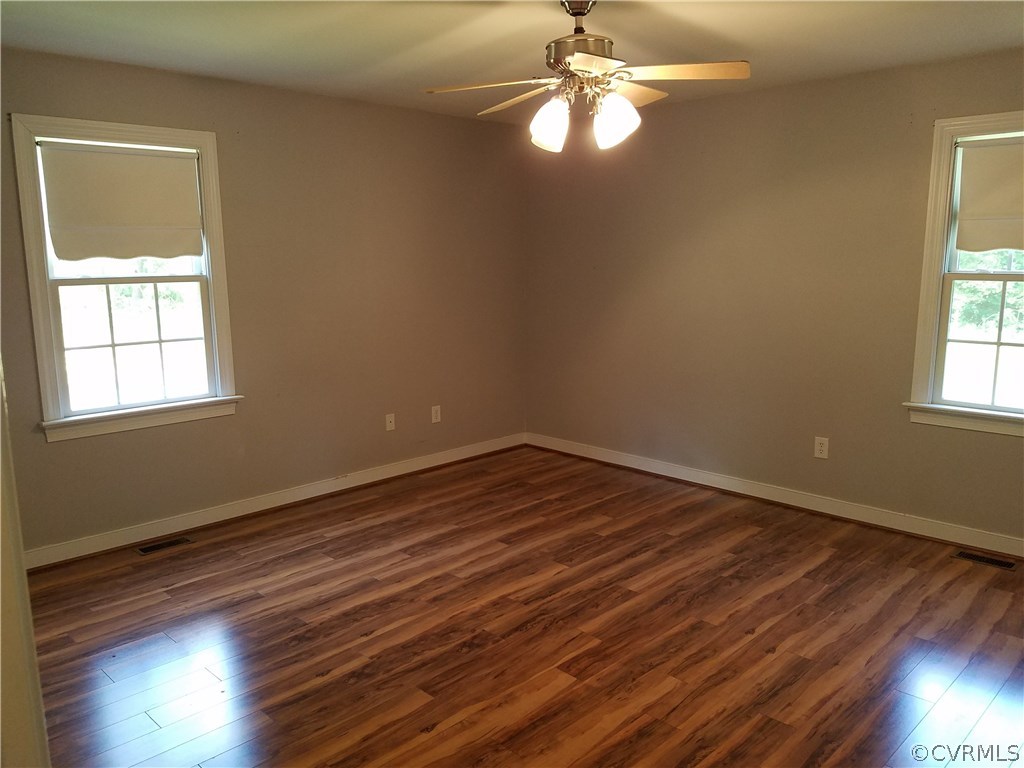 2238 Wickham Road Bumpass, VA 23024 - Photo 5 of 15 a view of empty room with wooden floor and fan