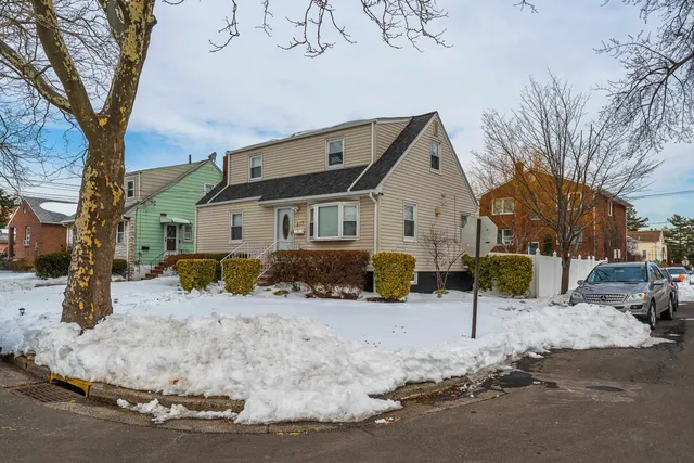 a view of a house with a yard covered in snow