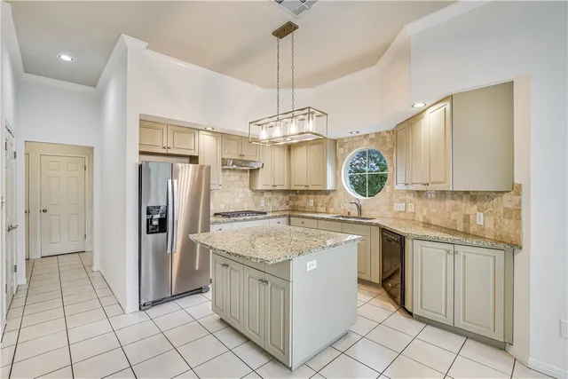 a kitchen with a cabinets and chandelier