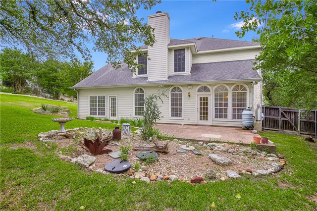 a view of a house with backyard sitting area and garden