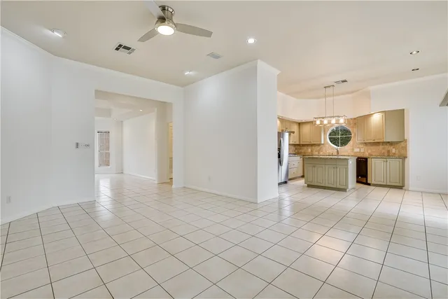 a view of a kitchen with furniture and an empty room