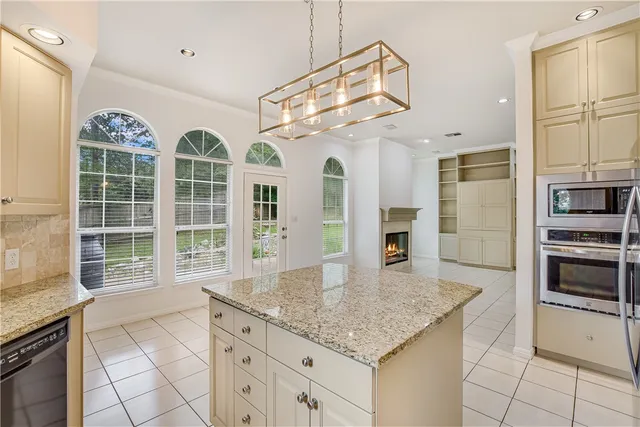 a kitchen with cabinets and chandelier