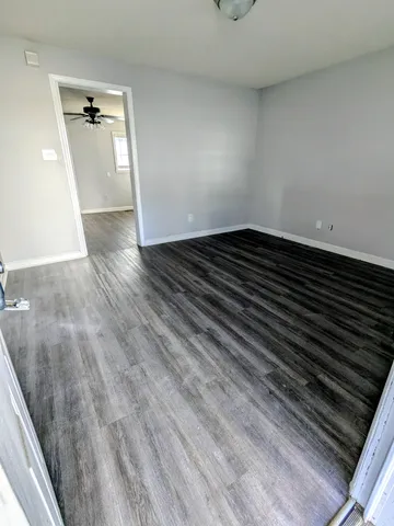 a view of an empty room and wooden floor