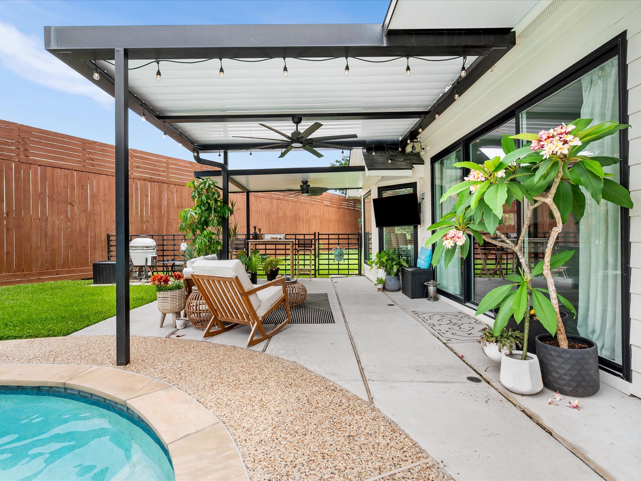 4023 Tigris Ridge Drive Katy, TX 77449 - Photo 30 of 39 A covered patio provides shaded outdoor living space perfect for year-round enjoyment. The louvered pergola enhances flexibility for shade and comfort while enjoying the backyard.