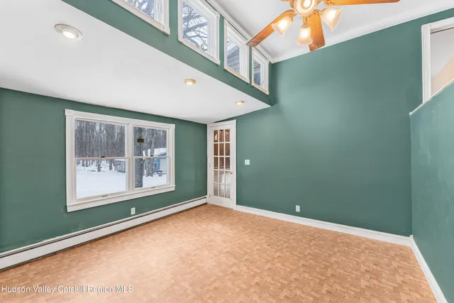 a view of an empty room with kitchen