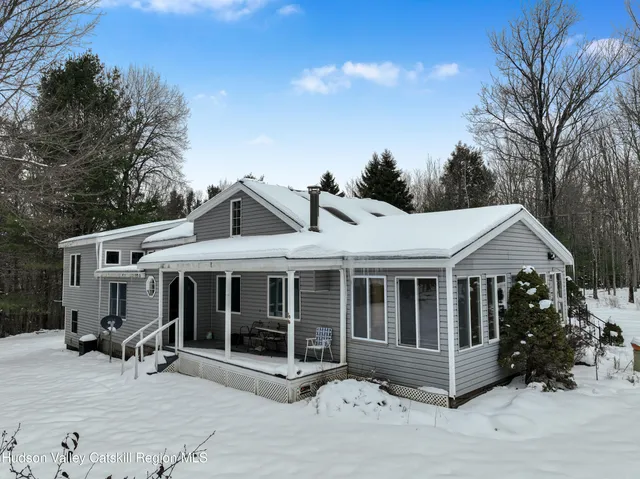 a view of a house with a yard and sitting area