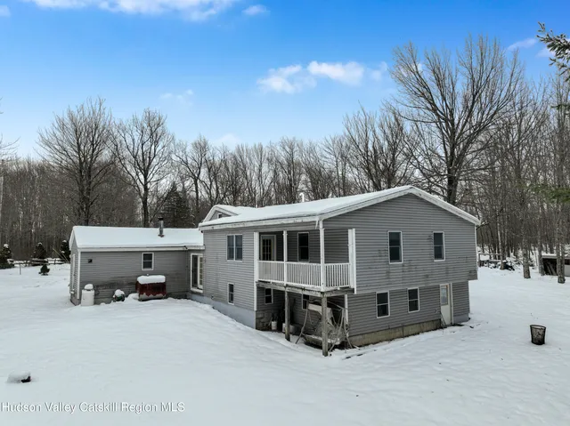a view of a house with a yard and trees