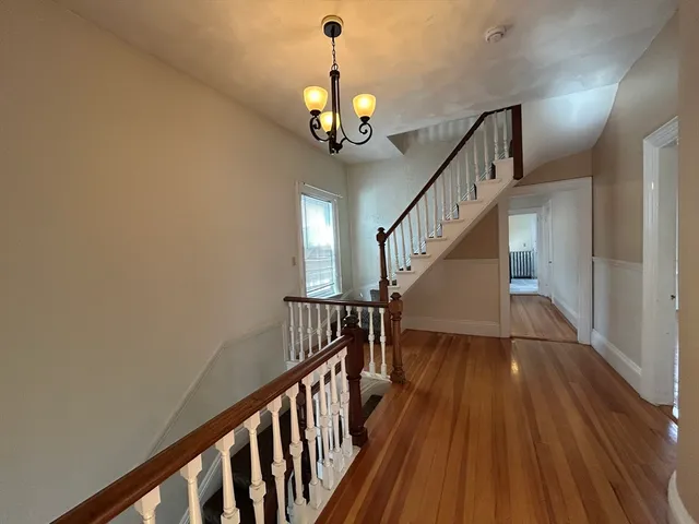 a view of entryway and hall with wooden floor
