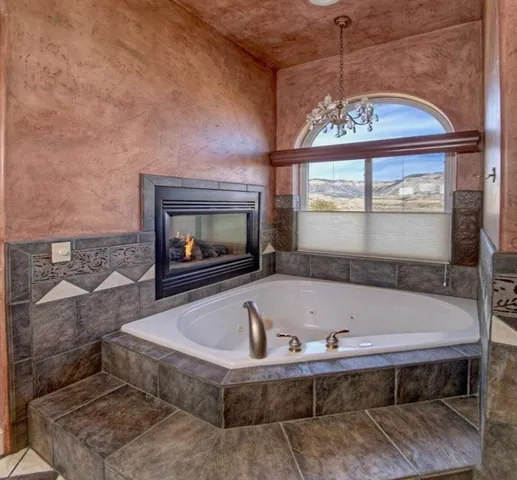 a bath tub sitting in a bathroom next to a window