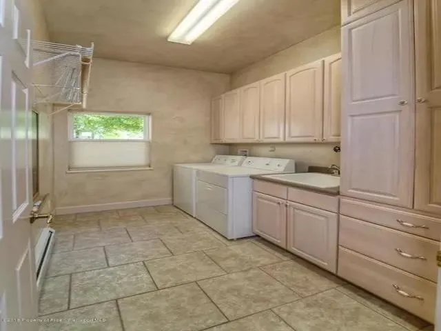 a kitchen with a stove a sink and a refrigerator