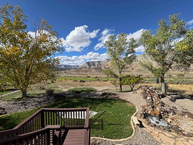 a view of a roof deck with wooden fence and floor