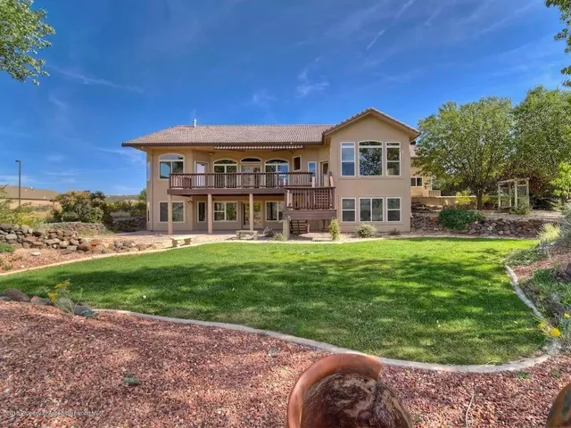 a front view of a house with a yard table and chairs