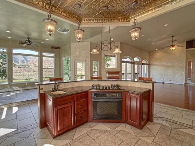 a large kitchen with a sink and dishwasher with a stove