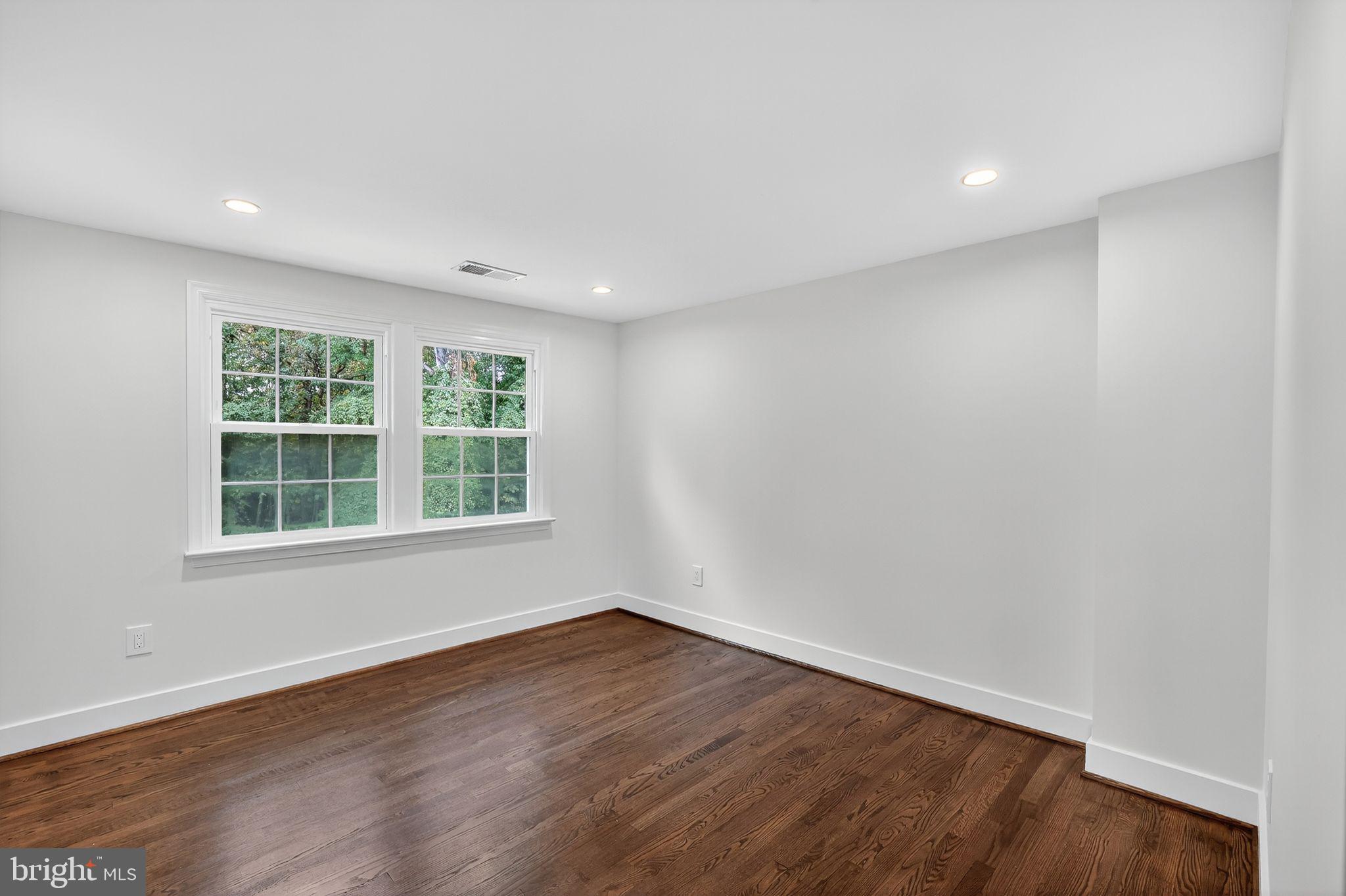 3428 Beret Lane Silver Spring, MD 20906 - Photo 24 of 33 an empty room with wooden floor and windows