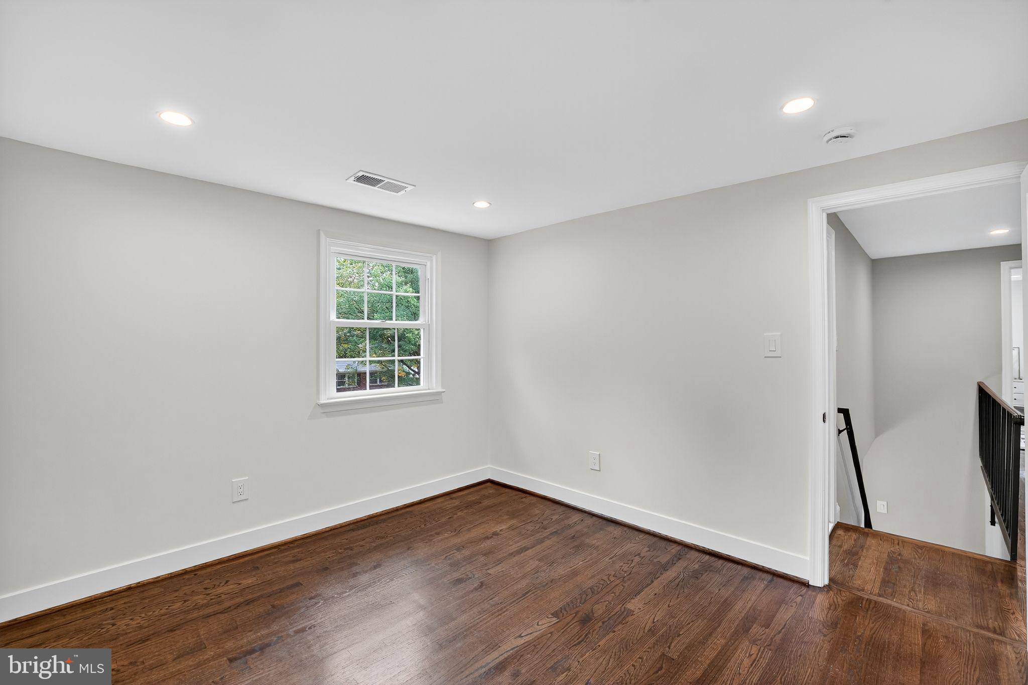 3428 Beret Lane Silver Spring, MD 20906 - Photo 27 of 33 a view of an empty room with wooden floor and a window