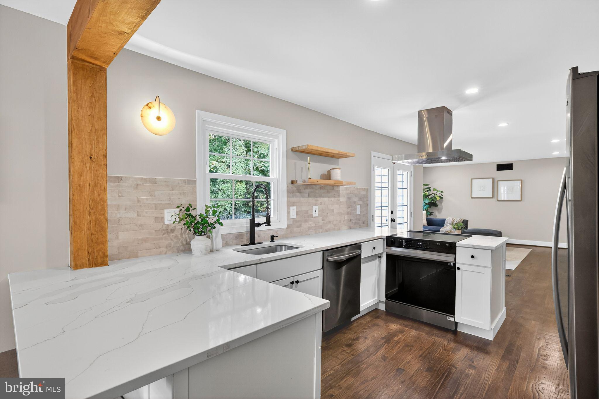 3428 Beret Lane Silver Spring, MD 20906 - Photo 7 of 33 a kitchen with stainless steel appliances granite countertop a sink stove and refrigerator