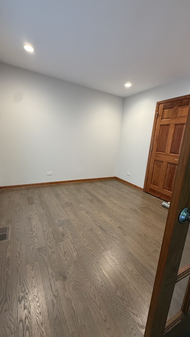 2841 Orange Brace Road Deerfield, IL 60015 - Photo 12 of 30 an empty room with wooden floor and fan