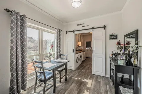 a view of a livingroom with furniture wooden floor and a table