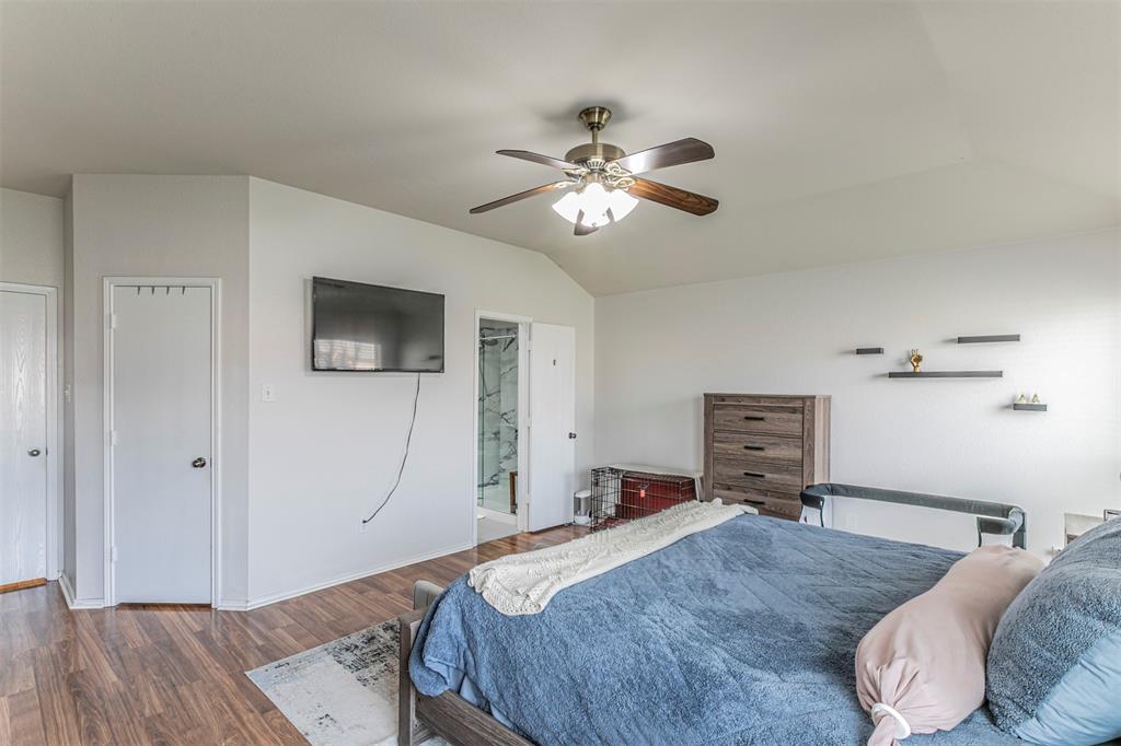 3433 Charing Cross Road Midlothian, TX 76065 - Photo 12 of 27 a bedroom with a bed and a chandelier