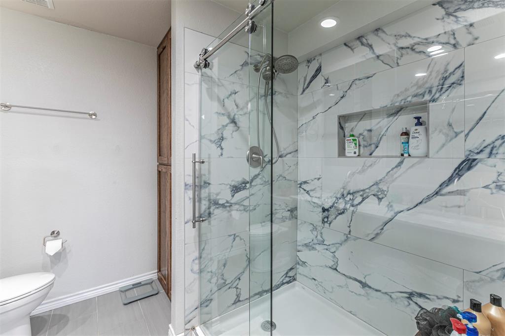 3433 Charing Cross Road Midlothian, TX 76065 - Photo 15 of 27 a bathroom with a shower and a toilet