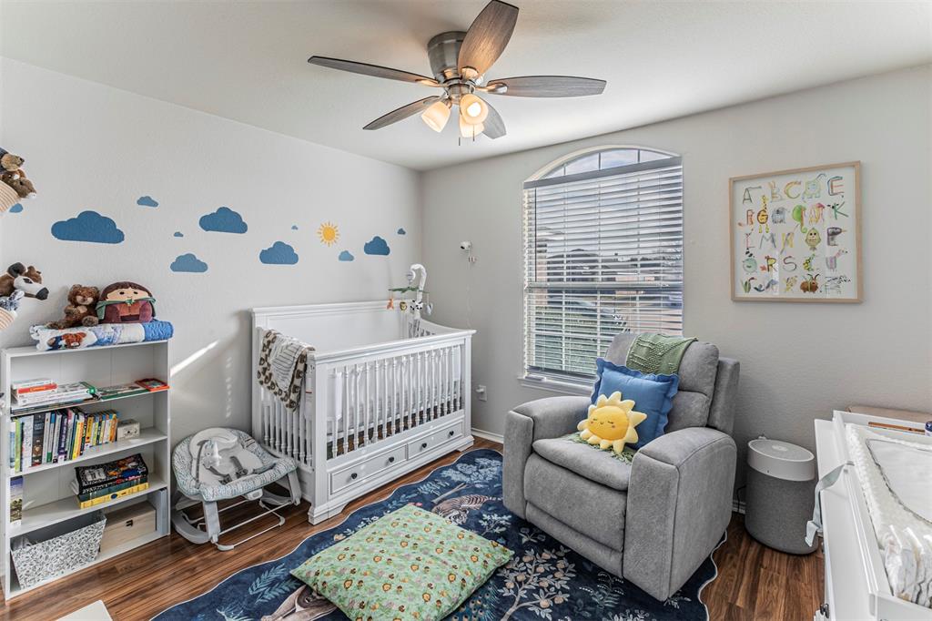 3433 Charing Cross Road Midlothian, TX 76065 - Photo 16 of 27 a bedroom with furniture and a book shelf