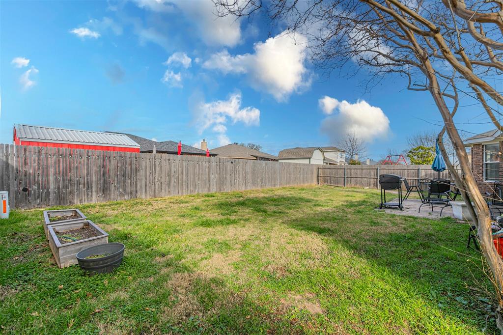 3433 Charing Cross Road Midlothian, TX 76065 - Photo 26 of 27 a backyard of a house with table and chairs