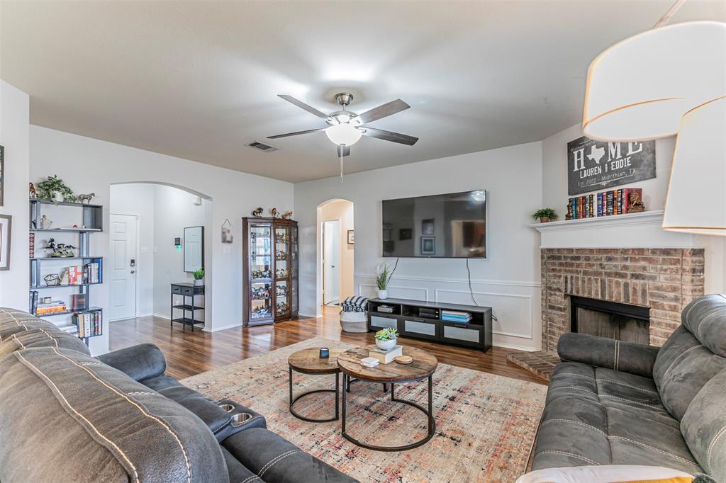 3433 Charing Cross Road Midlothian, TX 76065 - Photo 6 of 27 a living room with furniture a flat screen tv and a fireplace