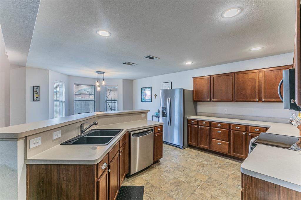 3433 Charing Cross Road Midlothian, TX 76065 - Photo 7 of 27 a kitchen with stainless steel appliances granite countertop a sink and a stove