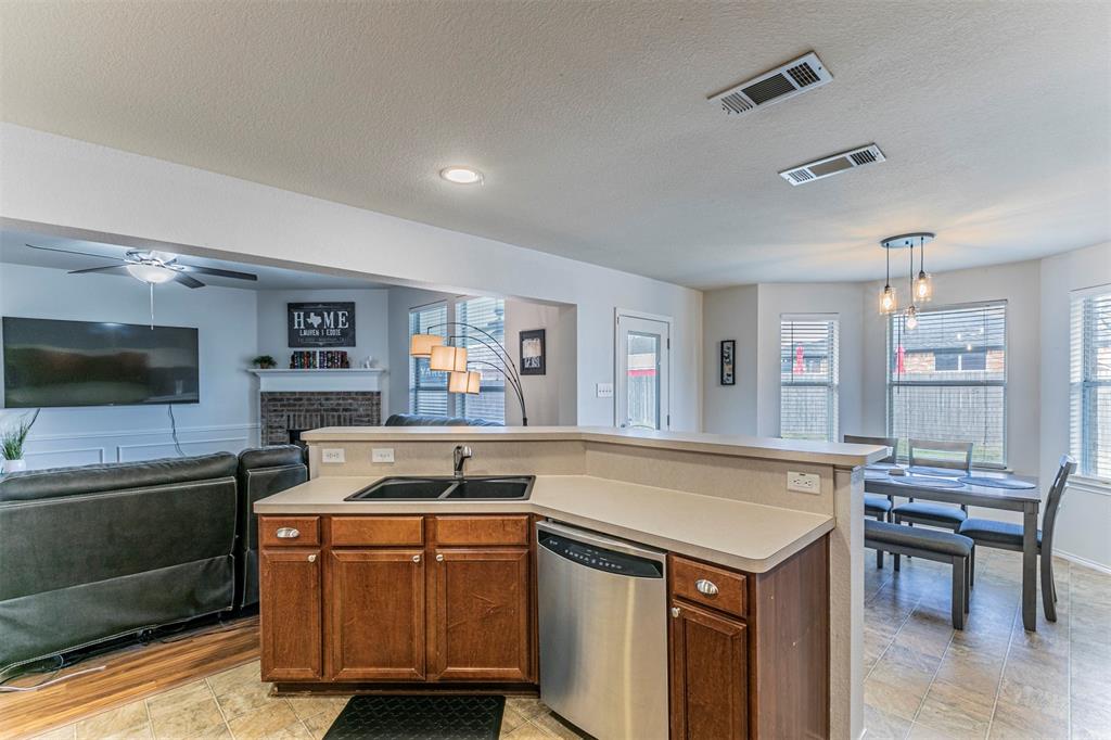 3433 Charing Cross Road Midlothian, TX 76065 - Photo 9 of 27 a kitchen that has a sink and a stove in it