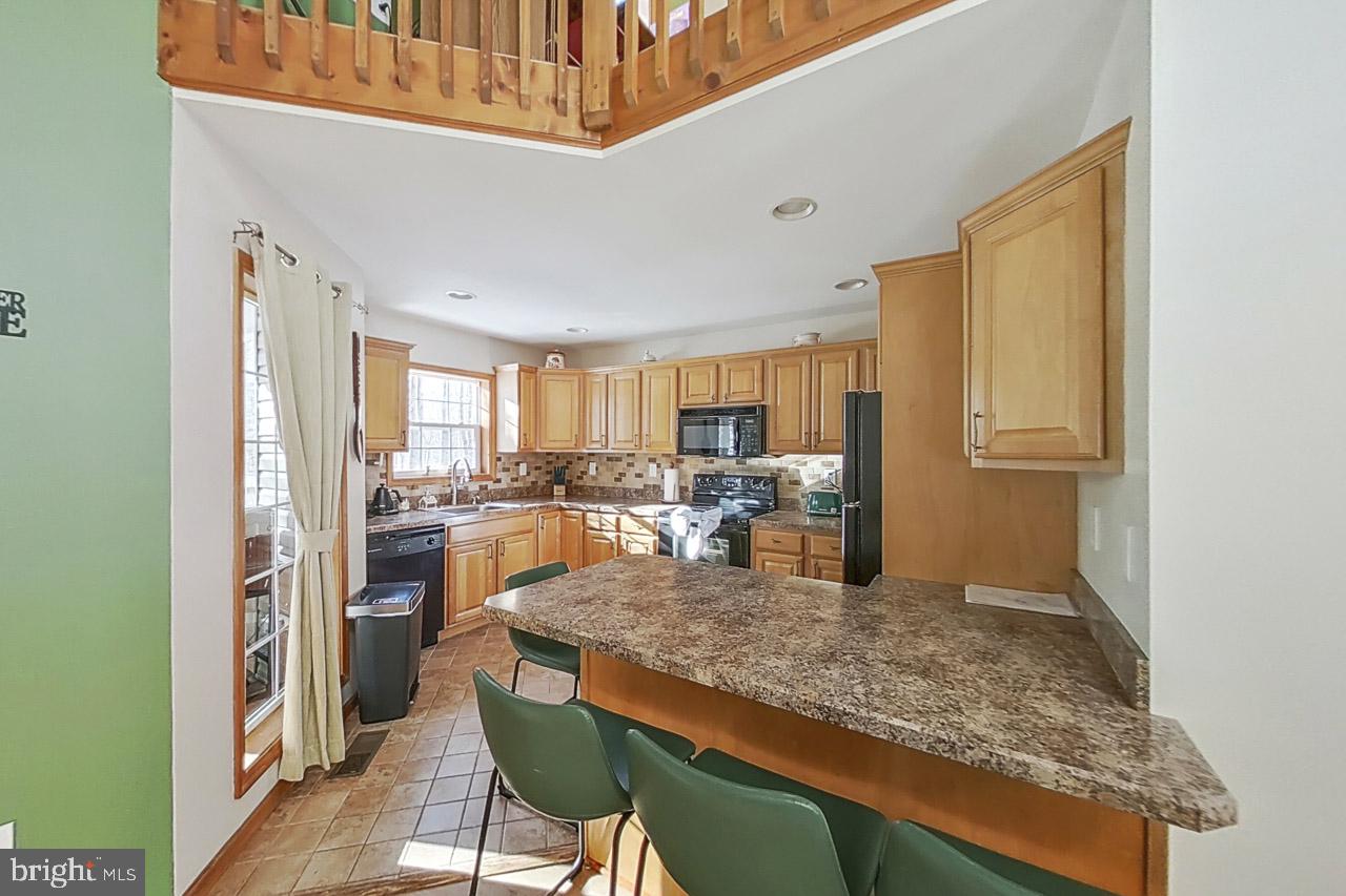 1122 Ranger Trail Pocono Lake, PA 18347 - Photo 12 of 48 Inviting kitchen with warm wood tones.