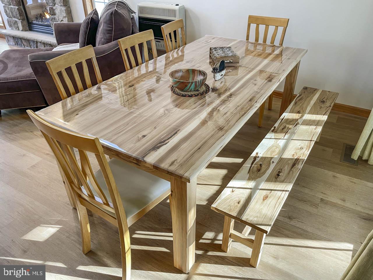 1122 Ranger Trail Pocono Lake, PA 18347 - Photo 15 of 48 Elegant wooden dining set in sunlight.