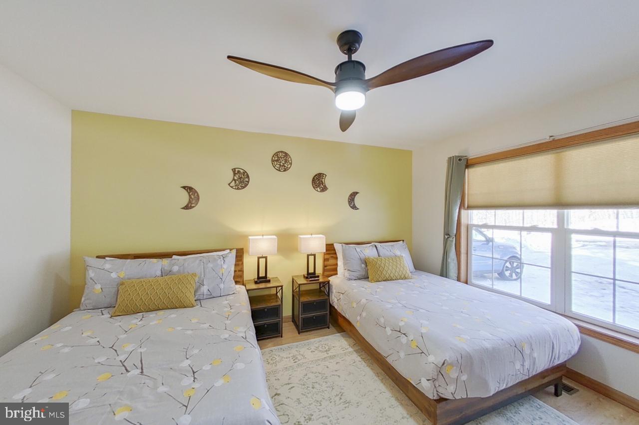 1122 Ranger Trail Pocono Lake, PA 18347 - Photo 21 of 48 Serene twin bedroom with natural light.