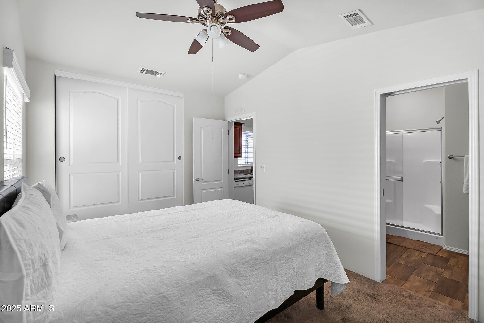 8865 East Baseline Road, Unit 802 Mesa, AZ 85209 - Photo 12 of 44 a bedroom with a bed and a chandelier
