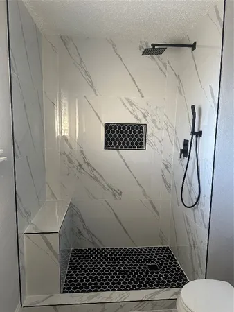 a bathroom with a sink toilet and shower