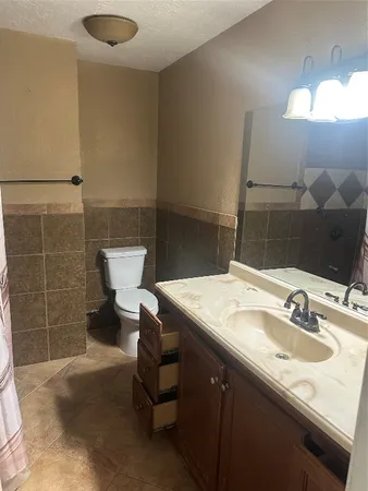 a bathroom with a sink vanity and a mirror