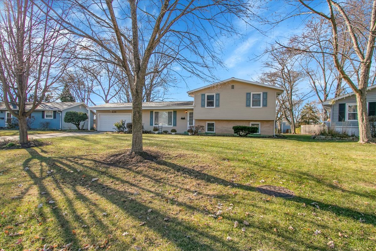 a view of a house with a yard covered in snow