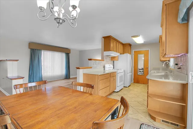 a spacious bedroom with a bed and a view of kitchen