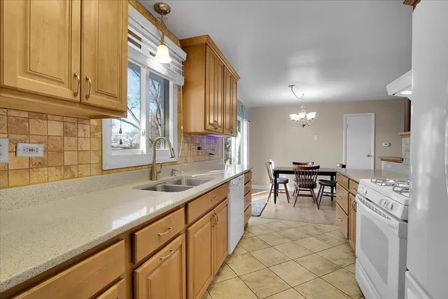 a kitchen with kitchen island granite countertop a sink cabinets and stove top oven