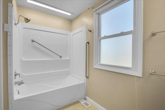 a bathroom with a bathtub and a shower