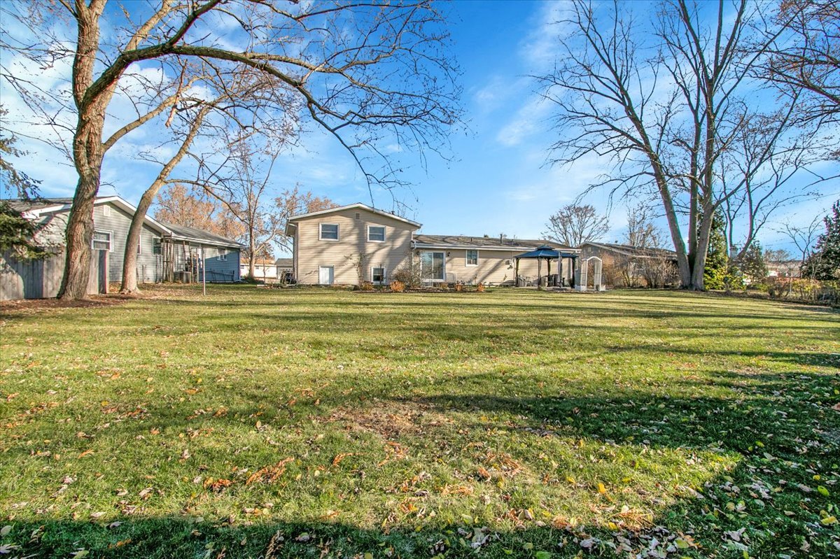 426 Thunderbird Trail Carol Stream, IL 60188 - Photo 34 of 34 a view of swimming pool with a garden and trees