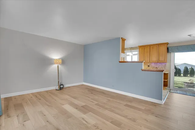 a view of a room with wooden floor and window
