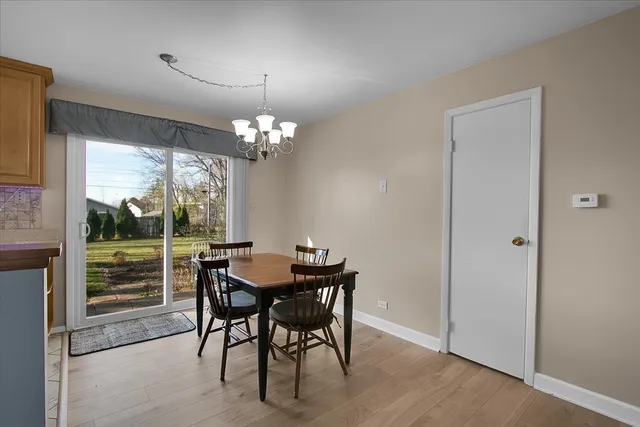 a dining room with furniture a chandelier and window