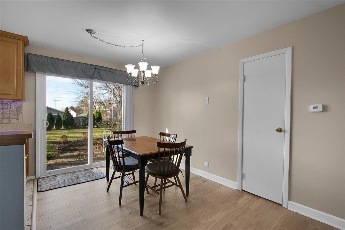 426 Thunderbird Trail Carol Stream, IL 60188 - Photo 9 of 34 a dining room with furniture a chandelier and window