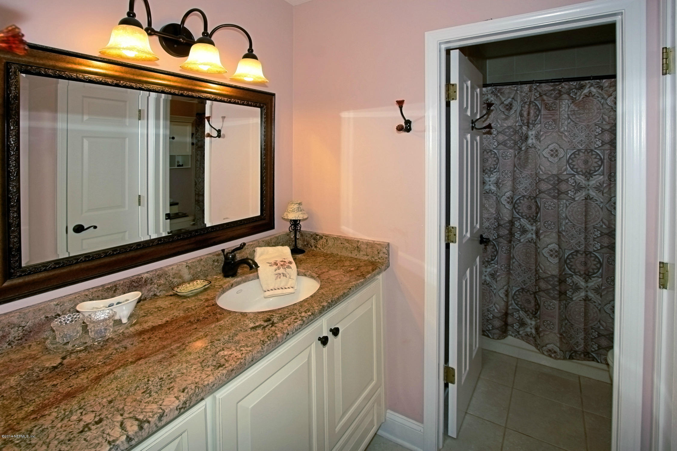 2740 Loretto Road Jacksonville, FL 32223 - Photo 16 of 29 a bathroom with a granite countertop sink and a mirror