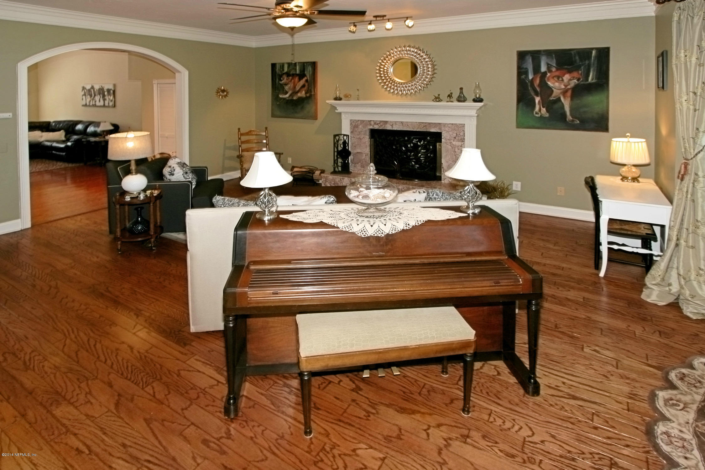 2740 Loretto Road Jacksonville, FL 32223 - Photo 4 of 29 a living room with furniture a fireplace and wooden floor
