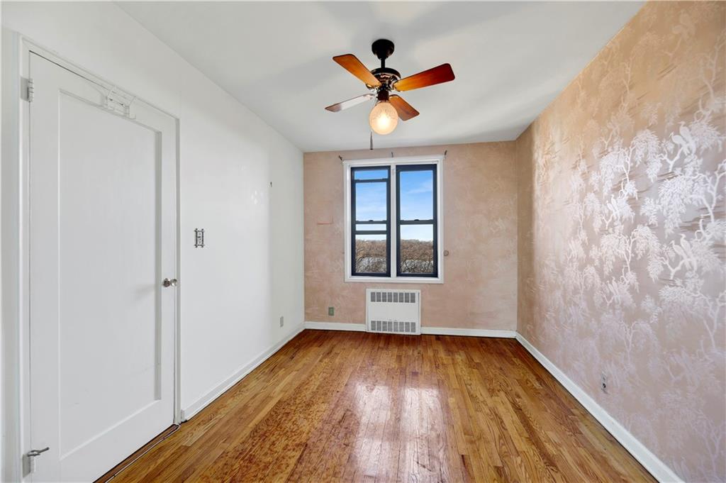 2260 Burnett Street, Unit 6K Brooklyn, NY 11229 - Photo 11 of 17 a view of empty room with wooden floor and fan