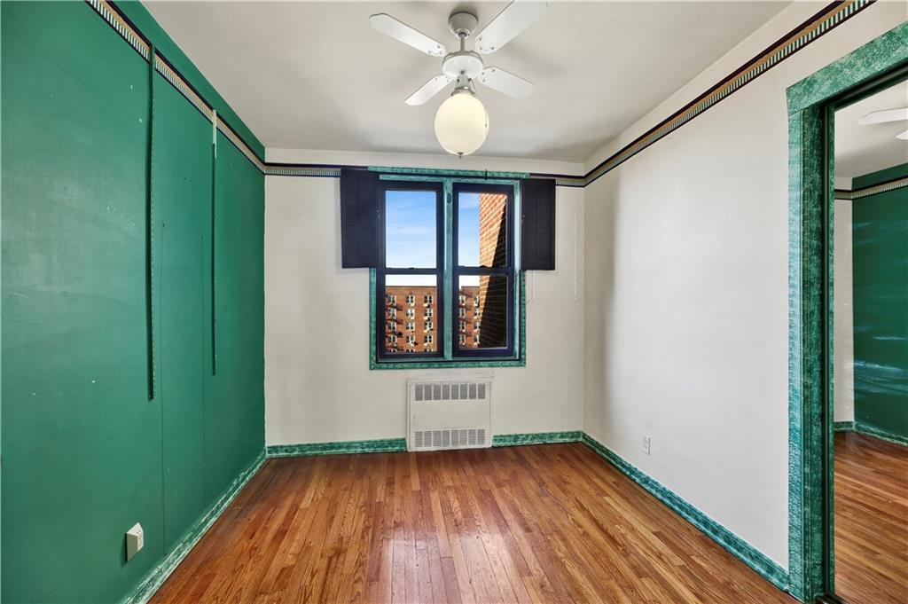 2260 Burnett Street, Unit 6K Brooklyn, NY 11229 - Photo 13 of 17 a view of an empty room with window and wooden floor