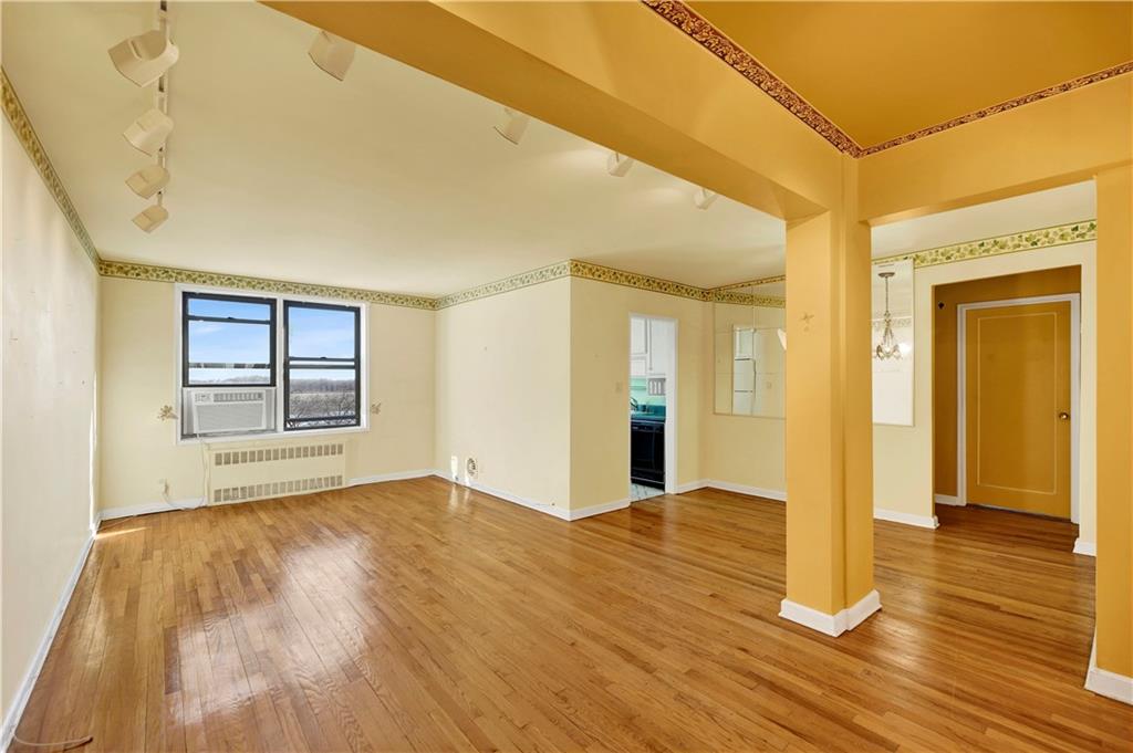 2260 Burnett Street, Unit 6K Brooklyn, NY 11229 - Photo 2 of 17 a view of an empty room with wooden floor and a window