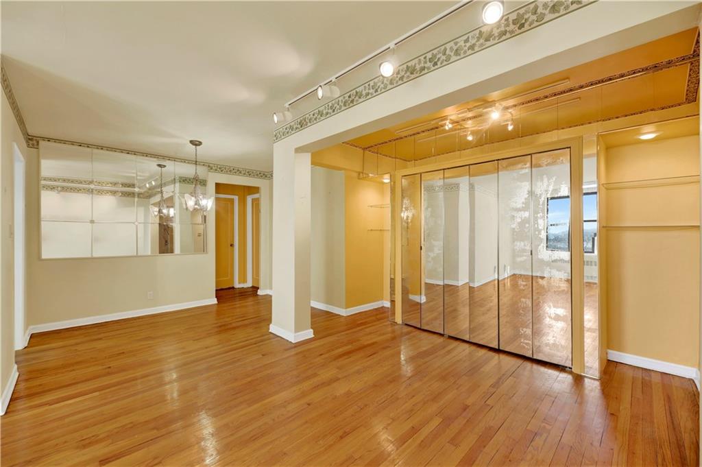 2260 Burnett Street, Unit 6K Brooklyn, NY 11229 - Photo 5 of 17 a view of an empty room with wooden floor and a window